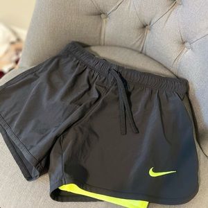 Black and green Nike athletic shorts
